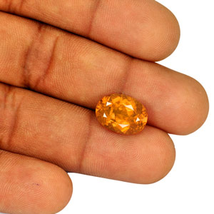 6.37-Carat Lustrous Intense Orange Oval-Cut Tajik Clinohumite - Click Image to Close