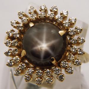 Ring containing a Black Star Sapphire surrounded with Diamonds